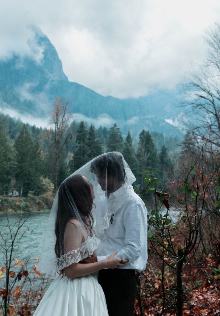 Skykomish River elopement couple standing on riverside rocks in Index WA