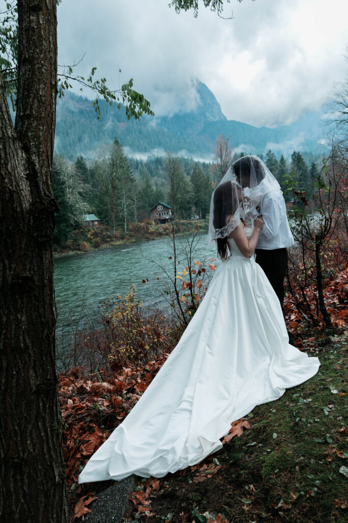 Skykomish River elopement couple standing on riverside rocks in Index WA