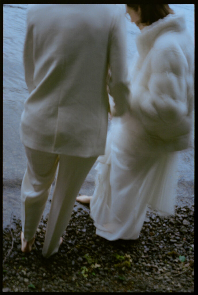 Double exposure composite of two brides dancing at Lake Crescent layered over an Olympic National Park trail map, with their wedding bands overlaid near the Hoh Rain Forest Visitor Center marker, created as a Washington elopement photographer editorial image.

